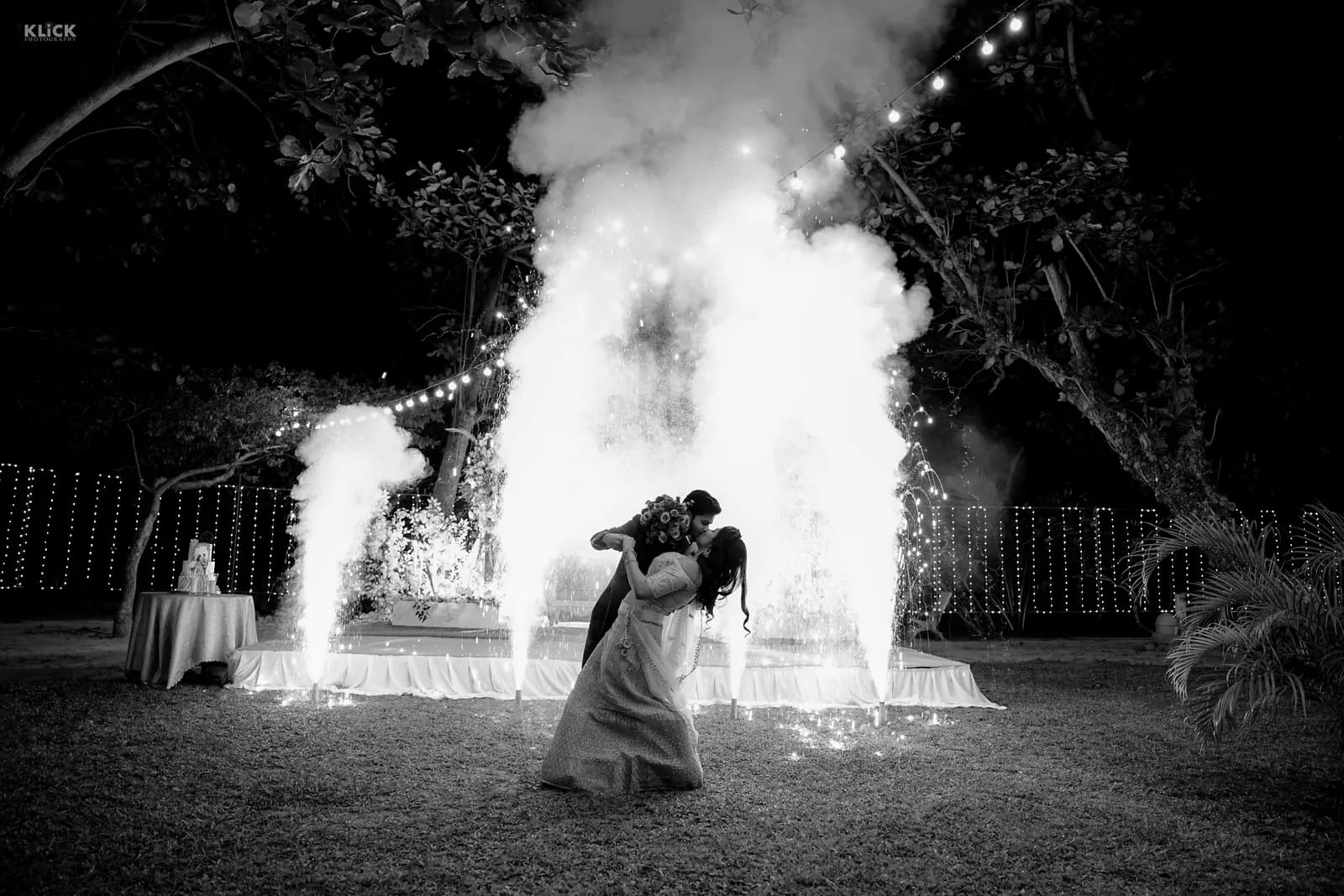 Black and white wedding portrait framed by sparkler fountains